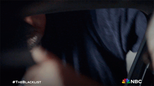 Man In Suit And Tie Smiling With NBC Logo GIF