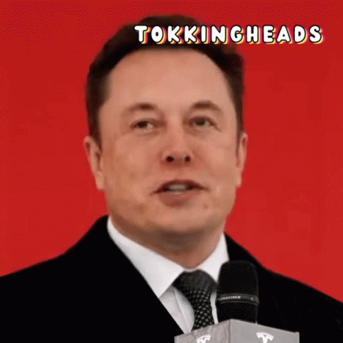 Man in Suit and Tie Speaking Into Microphone Tokingheads
