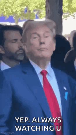Man in Suit and Tie Standing Before Crowd