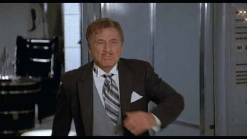 Man in Suit and Tie Standing by Locker