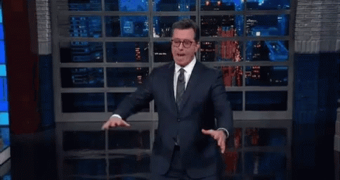 Man In Suit And Tie Standing By Window GIF