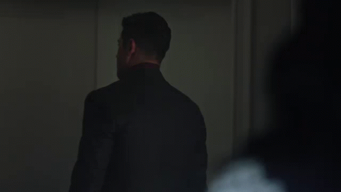 Man in Suit and Tie Standing in Dark