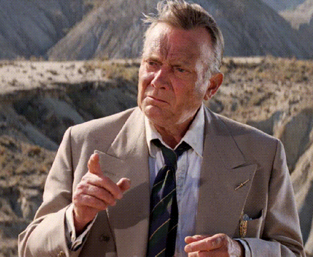 Man In Suit And Tie Standing In Desert GIF