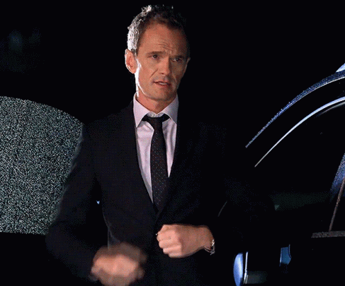 Man In Suit And Tie Standing In Front Of Black Car GIF