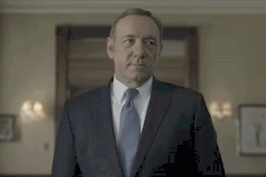 Man in Suit and Tie Standing in Front of Door