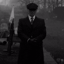 Man In Suit And Tie Standing In Front Of Flag And Gun GIF