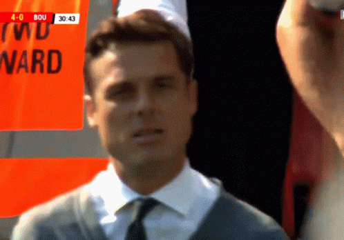 Man in Suit and Tie Standing in Front of Ward Sign