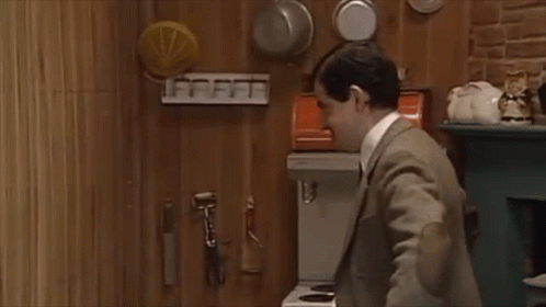 Man In Suit And Tie Standing In Kitchen GIF
