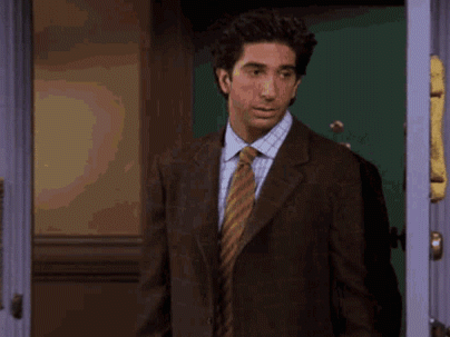 Man in Suit and Tie Standing with Arms Out