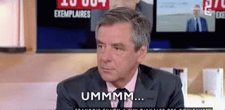 Man In Suit And Tie Talking By TV GIF