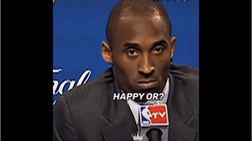 Man in Suit and Tie Talking Into NBA TV Microphone