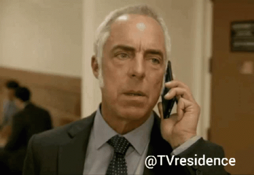 Man in Suit and Tie Talking on Cell Phone @tvresidence