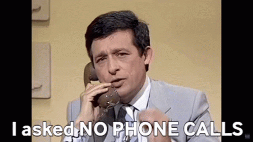 Man in Suit and Tie Talking on Phone