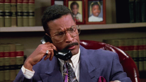 Man In Suit And Tie Talking On Phone GIF