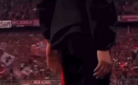 Man in Suit and Tie Talking to Red Shirt Soccer Player