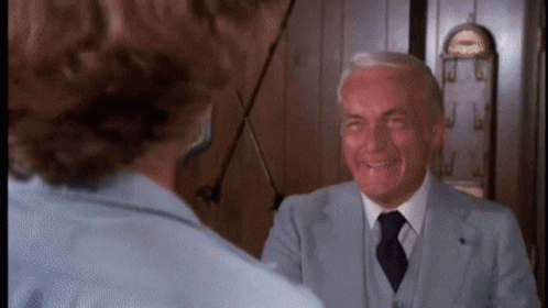 Man in Suit and Tie Talking to Woman
