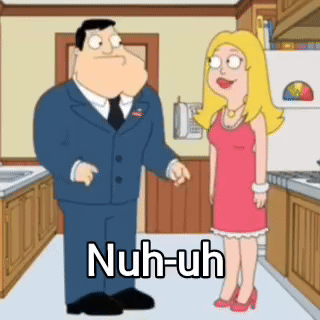 Man in Suit and Tie Talking to Woman in Red Dress in Kitchen