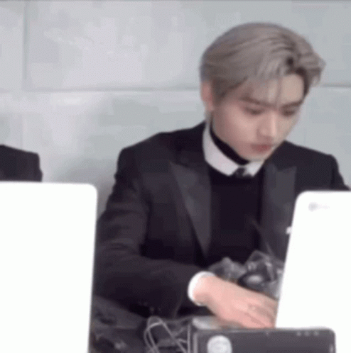 Man in Suit and Tie Using Laptop