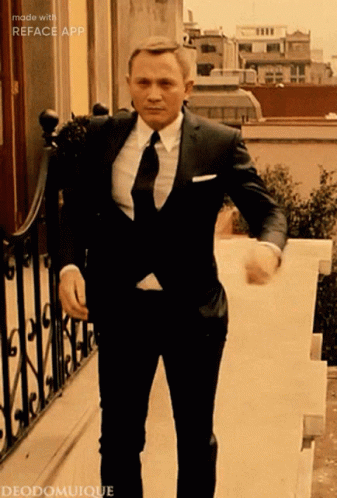 Man in Suit and Tie Walking Down Stairs