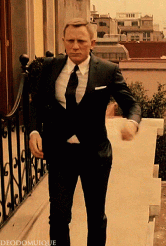 Man in Suit and Tie Walking Down Stairs with deodomuique