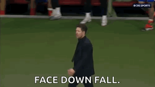 Man in Suit and Tie Walking on Soccer Field