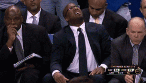 Man in Suit and Tie Watching Basketball
