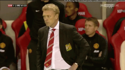 Man in Suit and Tie Watching Soccer Game