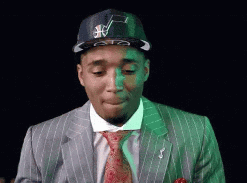 Man In Suit And Tie Wearing Basketball Hat GIF