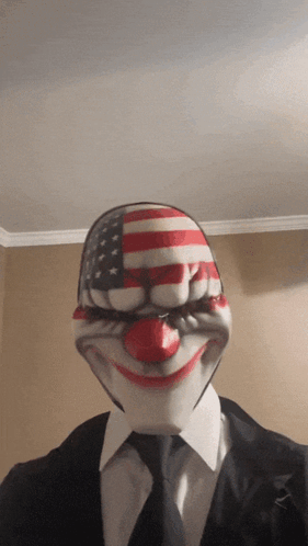 Man In Suit And Tie Wearing Clown Mask GIF