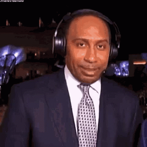 Man in Suit and Tie Wearing Headphones