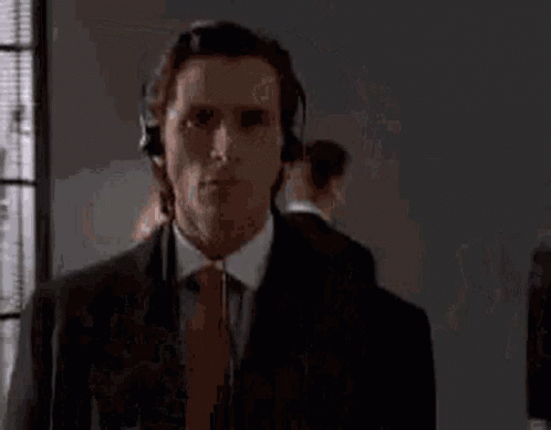 Man in Suit and Tie Wearing Headphones
