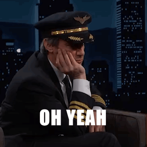 Man in Suit and Tie Wearing Pilot Hat