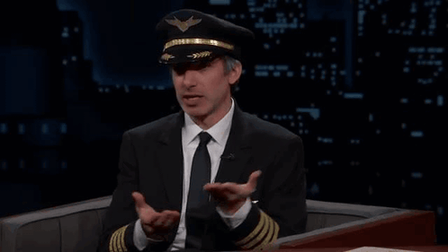 Man in Suit and Tie Wearing Pilot Hat