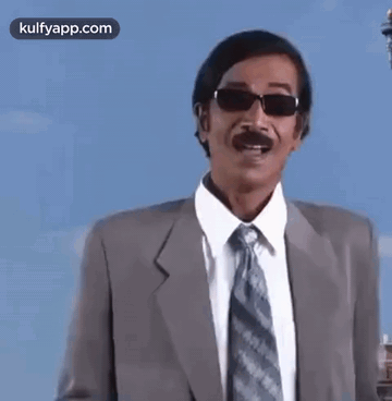 Man In Suit And Tie Wearing Sunglasses Pointing GIF