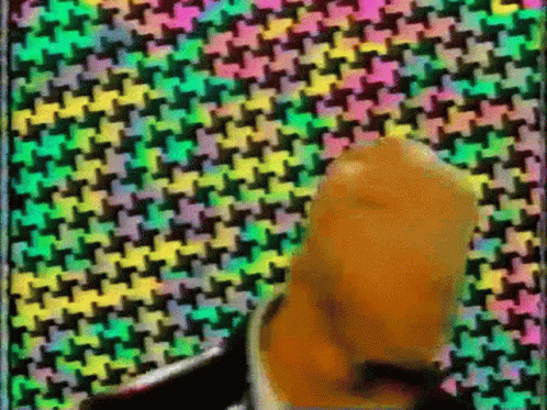 Man In Suit And Tie With Colorful Geometric Pattern GIF