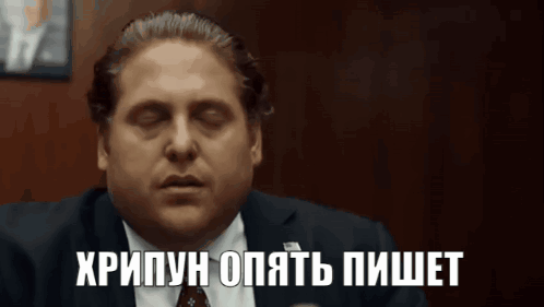 Man In Suit And Tie With Foreign Language On Face GIF