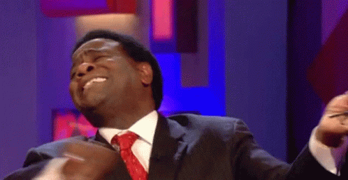 Man In Suit And Tie With Funny Face Pointing GIF
