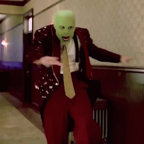 Man In Suit And Tie With Green Mask GIF