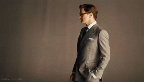 Man In Suit And Tie With Hands In Pockets And Glasses GIF