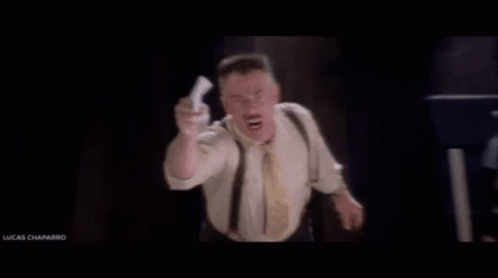 Man In Suit And Tie With He's Back Sign GIF
