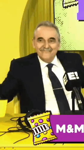 Man In Suit And Tie With M&M Candy GIF