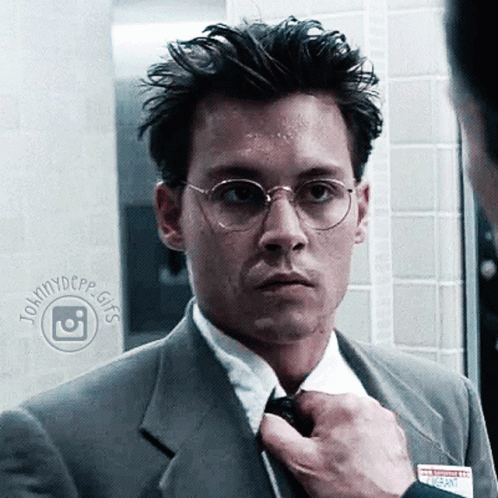 Man in Suit and Tie With Name Tag Saying Johnnydcpp Gifs