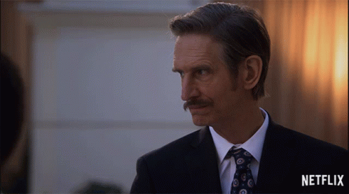 Man in Suit and Tie With Netflix Logo