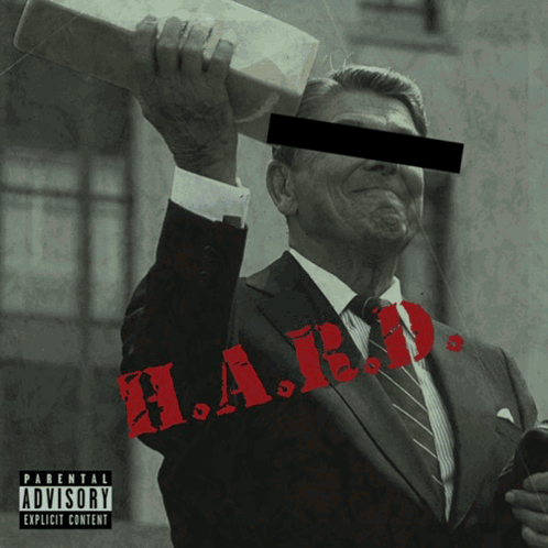 Man in Suit and Tie With Parental Advisory Label
