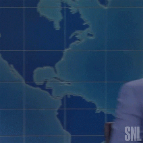 Man in Suit and Tie with SNL Logo