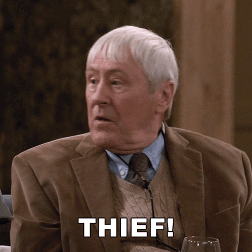Man In Suit And Tie With Thief On Face GIF