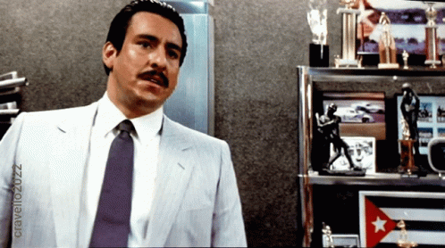Man in Suit and Tie with Trophies