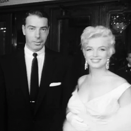 Man in Suit and Tie, Woman in Dress