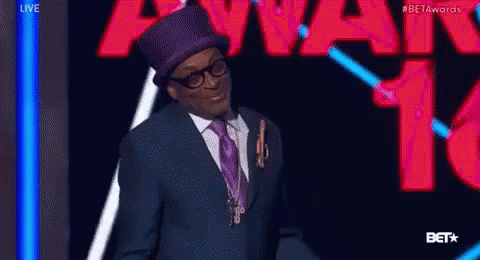 Man in Suit and Top Hat with Beta Awards Sign