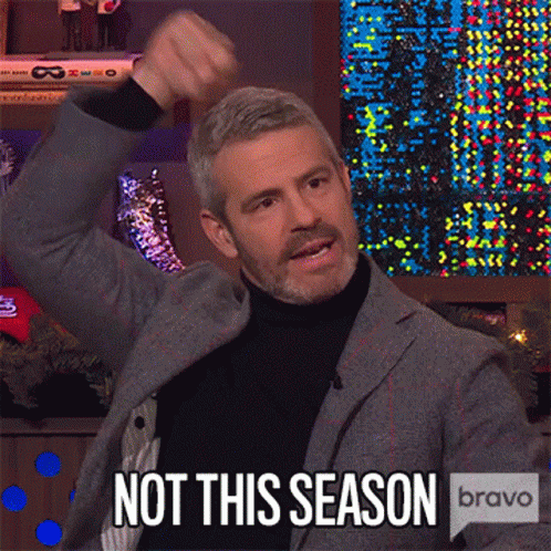 Man in Suit and Turtleneck Raising Fist Saying Not This Season